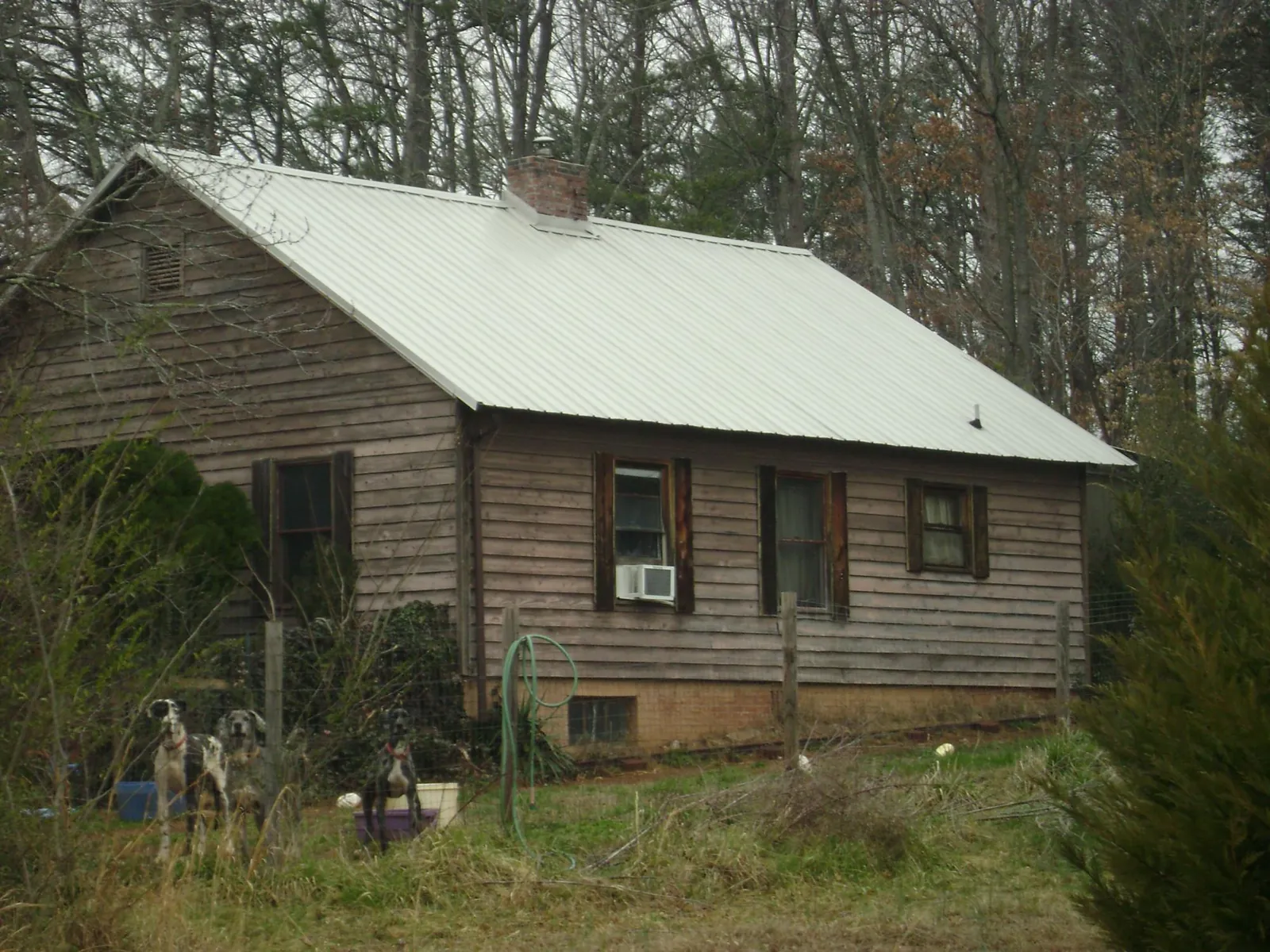 White metal roof on an old wood sided farmhouse, from a Metal Roof Installation job in Adair